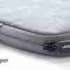 UGREEN UG-20476 14″ laptop sleeve case front view in grey Open laptop sleeve showing crystal velvet interior with soft padding Side zipper detail of the UGREEN laptop case Slim profile of UGREEN 14″ sleeve on a desk beside a laptop Water resistance feature demonstrated with drops on PU leather surface Professional carrying UGREEN grey laptop sleeve into a meeting