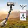 "Ugreen LP680 selfie stick tripod with phone attached and Bluetooth remote" "Folded Ugreen LP680 tripod in compact travel-friendly form" "Close-up of detachable Bluetooth remote on Ugreen selfie stick" "Ugreen LP680 used as tripod stand for smartphone" "Adjustable selfie stick extended with anti-slip grip handle" "Portable black Ugreen selfie stick tripod on white background"