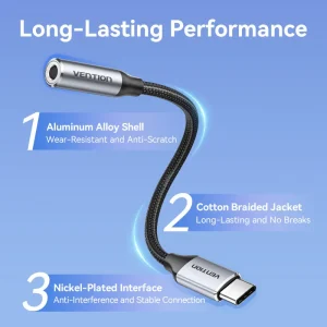 Vention BGMHA USB-C to 3.5 mm adapter cable showing gray aluminum alloy housing Close-up of gold-plated USB-C connector and 3.5 mm jack on the Vention adapter Vention DAC adapter plugged into a Pixel smartphone with earphones attached Side profile of the slim 0.1 m Vention audio adapter against a white background Vention audio adapter alongside a pair of 3.5 mm headphones and USB-C laptop port Cable shot highlighting the braided PVC jacket and aluminum housing of the adapter