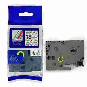 Compatible Brother TZ2-141 18mm black on clear label roll Black on clear label applied to glass surface Brother P-Touch printer with TZ2-141 tape installed Close-up of transparent label with black text TZ2-141 compatible tape used on office folders Packaging of 18mm clear laminated label tape