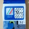Compatible Brother TZ2-131 12mm black on clear label tape roll Transparent label printed with black text on glass TZ2-131 installed in Brother P-Touch label printer Label on office folder using clear tape Close-up of 12mm black on clear laminated tape Compatible TZ2-131 tape cartridge and packaging