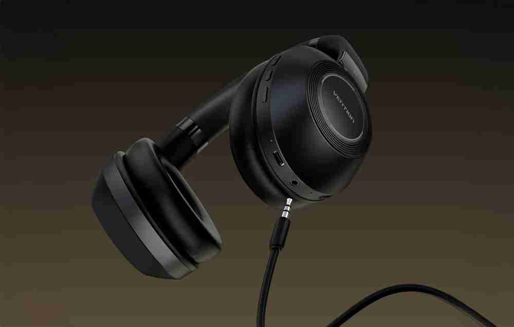 Vention SoundMate NBBB0 wireless headphones front view Side angle of Vention on-ear Bluetooth headphones Vention SoundMate NBBB0 with soft ear cushions Built-in control buttons on Vention wireless headphones Vention headphones charging via USB cable Lifestyle image of Vention headphones in use with mobile device