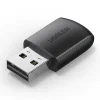 UGREEN AX300 USB WiFi Adapter front view AX300 Wi-Fi 6 dongle inserted in a laptop USB port Compact design of UGREEN CM760 35262 WiFi dongle Dual-band USB WiFi adapter side profile UGREEN USB-A wireless dongle close-up AX300 adapter shown next to a laptop and router
