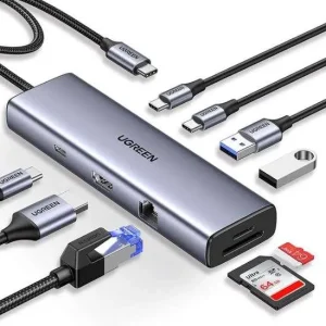 UGREEN CM498 9-in-1 Docking Station with multiple USB 3.0 and HDMI ports HDMI and VGA output ports on UGREEN CM498 docking station 100W PD charging port for laptops and tablets on UGREEN CM498 SD/TF card readers on UGREEN CM498 Docking Station Compact and portable UGREEN CM498 9-in-1 Docking Station UGREEN CM498 connected to a laptop with peripherals attached