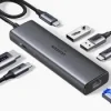 UGREEN CM512 6-in-1 Docking Station with multiple USB 3.0 and HDMI ports HDMI output and Gigabit Ethernet on UGREEN docking station 100W PD charging port for laptops and tablets on UGREEN CM512 Compact and portable UGREEN CM512 Docking Station in use Close-up of UGREEN docking station showing USB, HDMI, and Ethernet ports UGREEN CM512 connected to a laptop, providing 4K output and high-speed internet