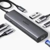 UGREEN CM512 6-in-1 Docking Station with multiple USB 3.0 and HDMI ports HDMI output and Gigabit Ethernet on UGREEN docking station 100W PD charging port for laptops and tablets on UGREEN CM512 Compact and portable UGREEN CM512 Docking Station in use Close-up of UGREEN docking station showing USB, HDMI, and Ethernet ports UGREEN CM512 connected to a laptop, providing 4K output and high-speed internet