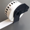 Brother DK-22210 continuous paper label roll front view Brother DK-22210 label roll 29mm width black on white Brother DK-22210 installed in Brother QL label printer Continuous label roll DK-22210 being cut to custom length Brother DK-22210 label roll packaging view Printed address label using Brother DK-22210 continuous roll