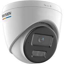 Hikvision 4MP ColorVu turret camera mounted on exterior wall Smart hybrid light CCTV camera with color night vision active Hikvision turret camera with siren and flashing strobe light Close-up of lens and built-in microphone speaker system Outdoor IP67 waterproof Hikvision security camera in rain Full-color night surveillance footage from Hikvision ColorVu camera
